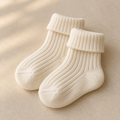 AI-generated concept of one pair of cream ribbed baby socks
